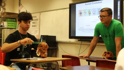 teacher with student who is measuring a skull